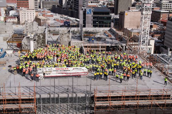 Top of K Block.  Construction workers in safety hats and vests.
